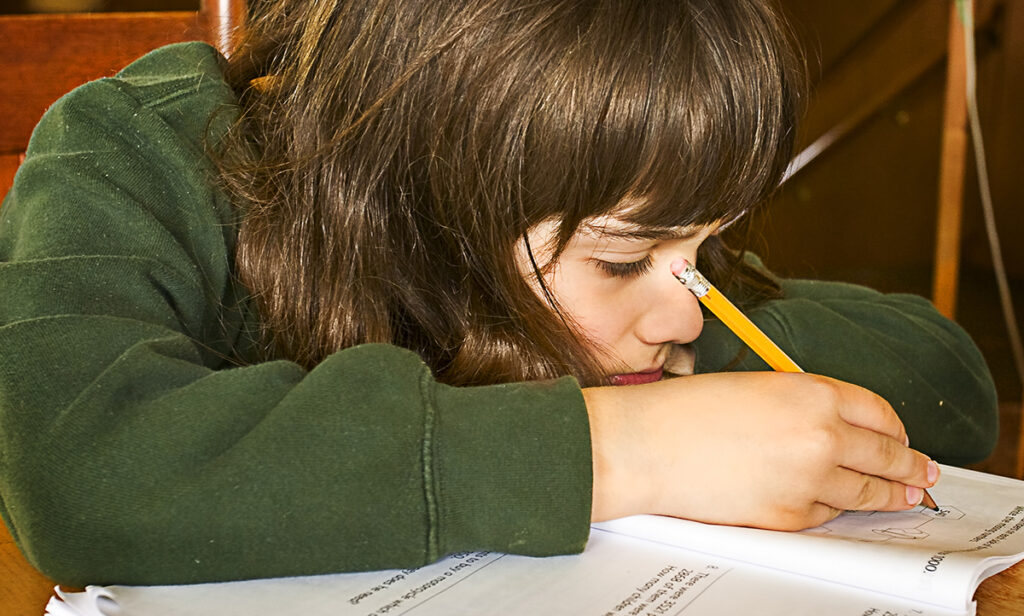 Tired student working on a test. [Randen Pederson (Creative Commons)]